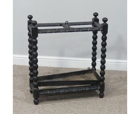 A Victorian carved dark oak division Umbrella Stand, with drip tray, brass carrying handle and bobbin turned supports, W 60cm