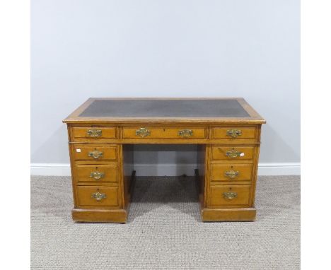 An Edwardian oak twin pedestal Desk, with leather inset top, with three frieze drawers below and three drawers to each side, 