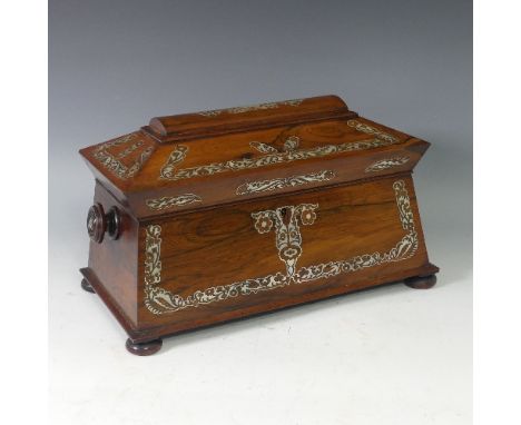A rosewood and mother of pearl Tea Caddy, of sarcophagus shape, the hinged lid opening to reveal a fitted interior, with two 