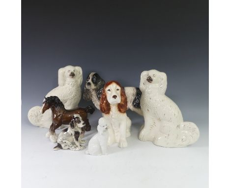 A pair of Staffordshire pottery Dogs, with painted features and gilt highlights, H 31cm, together with a Lladro Nao figure of