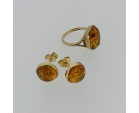 A modern 9ct gold and amber Ring, Size M, together with a pair of circular cabochon amber earrings, collet set in 14ct yellow