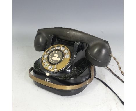 A Belgian Bell Rotary Telephone, having a metal back and brass dial, numbered RTT-56 A on underside, together with an oak cas