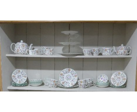 A Minton 'Haddon Hall' pattern Tea Service, comprising Teapot, Jugs, eleven Cups and Saucers, three tier Cake Stand, Tea Plat