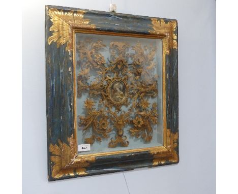 A 19th century Continental painted and rolled paper Reliquary Picture, with central oval portrait inscribed Sancta Margareta 