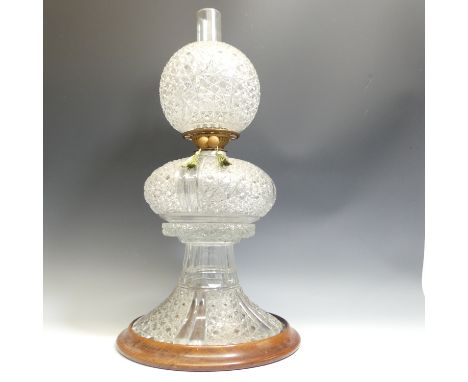 A 19thC Cut Crystal Oil Lamp, attributed to F &amp; C Osler on wooden base D14cm, H25cm without base, small chip on glass sha