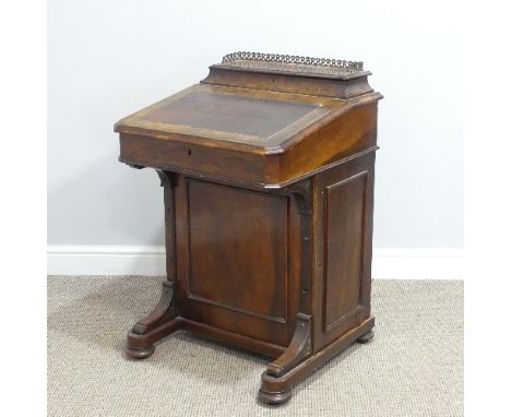 A Victorian walnut Davenport, the rectangular top with galleried stationery compartment, lifting to reveal two inkwells above