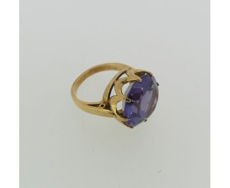 A synthetic colour change sapphire dress Ring, the circular facetted stone approx. 15mm diameter, claw set in 14ct yellow gol