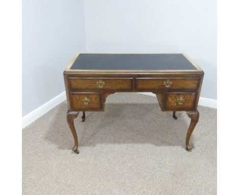 An early 20thC walnut Writing Desk, with rectangular top having inset writing skiver, above four drawers, all raised on cabri