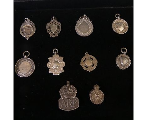 A collection of eight silver Watch / Prize Fobs, all with inscriptions, together with a silver ARP badge and a silver Regular