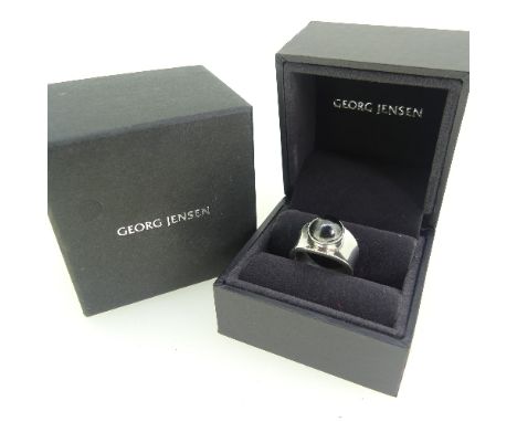 Georg Jensen; a silver Ring, set with a cabochon hematite, design no. 124, with London import marks for 1991, Size K, approx 