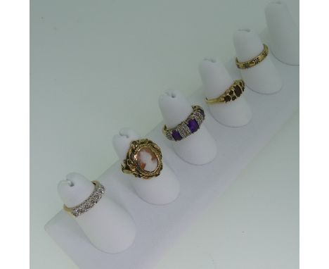 A 9ct gold and seven stone garnet Ring, with scroll gallery, Size O½, together with four other 9ct gold rings; one gypsy set 