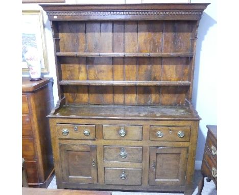 A 19th-century oak Welsh dresser and rack, the base with three frieze drawers above a pair of panel doors flanking two furthe