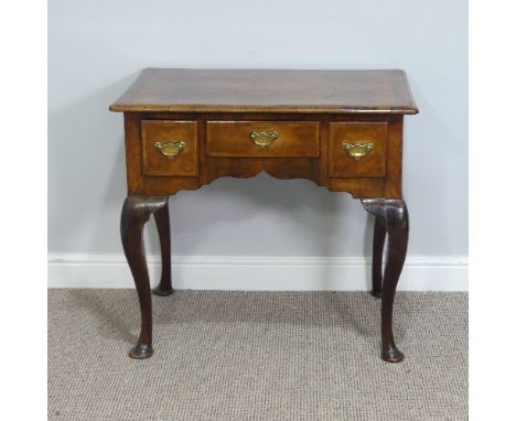 A Georgian walnut Lowboy, with quarter-veneered top above three frieze drawers, all raised on cabriole legs, W 76cm x D 50cm 