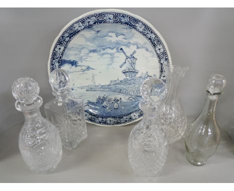 A box of five crystal decanters and carafe and a Delft blue and white charger **PLEASE NOTE THIS LOT IS NOT ELIGIBLE FOR IN-H