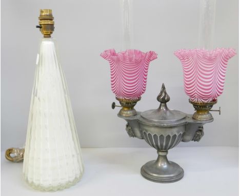 A pewter twin oil lamp with pink glass shades, one shade a/f and a mid 20th century glass table lamp base (2)