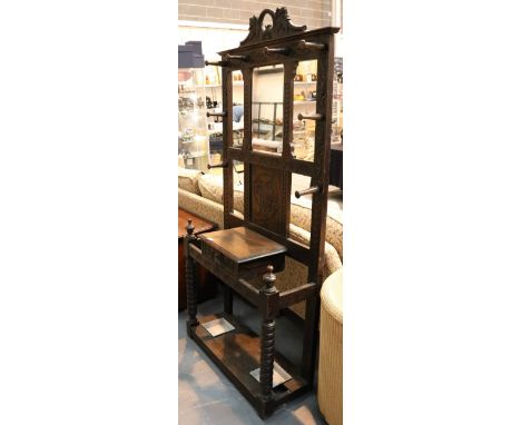 Dark oak Victorian hat, coat and stick stand with single drawer and mirror, on bobbin turned legs and carved foliat decoratio