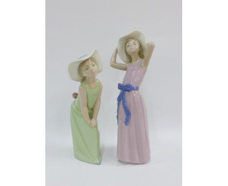 Two Lladro female figures, one wearing a lilac dress the other wearing green, with printed backstamps, tallest 27cm (2) 