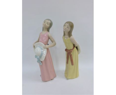 Two Lladro Diasa girl figures, one wearing a pink dress the other in yellow, with printed backstamps, tallest 25cm (2) 