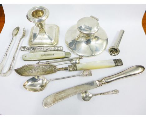 A collection of silver to include a capstan inkwell, sugar tongs, fruit knife, desk candlestick, etc (a lot) 