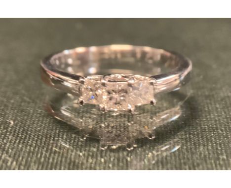 A diamond ring, with three stepped princess cut diamonds, total estimated diamond weight approx 0.52ct, 18ct white gold shank