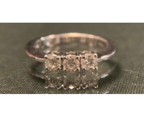 A diamond ring, set with three round brilliant certified diamonds, colour F-G, clarity SI2, total diamond weight 0.50ct, 18ct