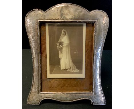 An Edwardian Arts and Crafts silver photograph frame, arched top, easel stand, S Blanckensee &amp; Son Ltd, Chester 1909, 30c