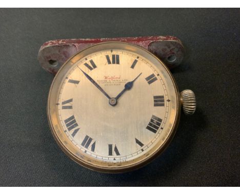 Automobilia - a vintage motor car dashboard clock, the 6cm silvered dial inscribed Watford, North & Sons, London, the mountin