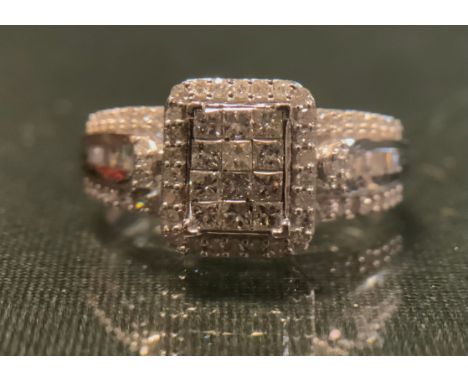 A diamond cluster ring, pave set with eighty princess, baguette and round brilliant cut diamonds, total estimated diamond wei