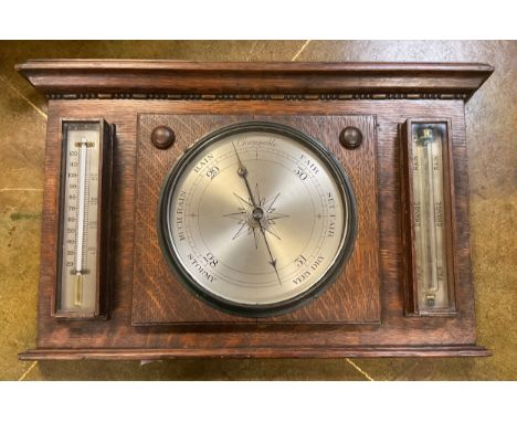 An Edwardian oak ACMA wall mounting weather station, barometer, thermometer, storm glass, 33cm x 54cm 
