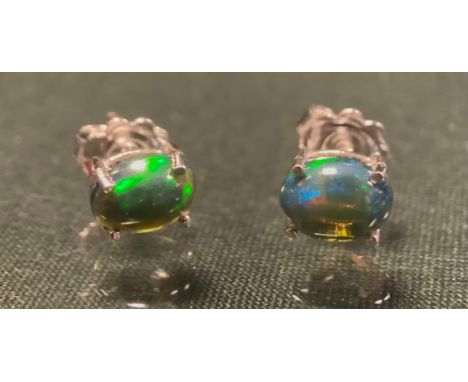 A pair of Ethiopian oval black opal cabochon earrings, silver mounts, stamped 925 (2) 