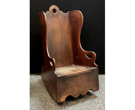 A late 18th century boarded child’s rocking chair/ commode, hinged seat, comprising of various woods including; elm, mahogany