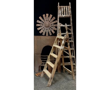 A pair of wooden six step folding ladders;  another smaller;   cast iron fire back;  wooden and metal wall plaque;  etc 