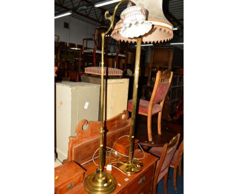 AN EARLY 20TH CENTURY BRASS COLUMNED STANDARD LAMP, together with another standard lamp with a glazed shade (2)