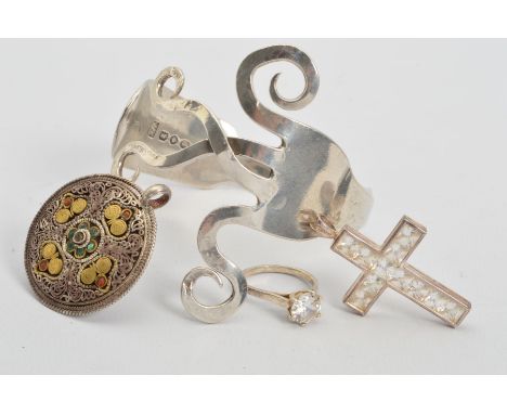 FOUR ITEMS OF SILVER AND WHITE METAL JEWELLERY, to include a silver fork bangle, with silver hallmark, a continental circular