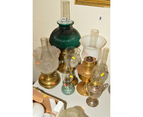 A COLLECTION OF SEVEN ASSORTED OIL LAMPS, FITTINGS AND CANDLE LAMP, to include a brass based lamp with green ribbed glass sha