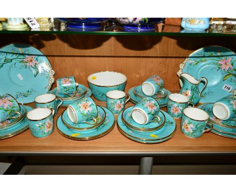 AN EDWARDIAN TEASET, florally handpainted on turquoise ground, to include two cake plates, milk jug, sugar bowl, cups, saucer