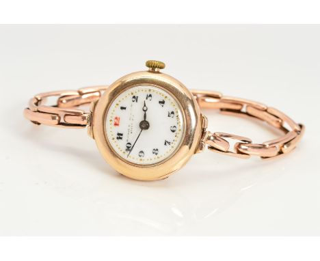 A 1920's 9CT GOLD LADY'S WRIST WATCH, the circular face with white dial, Arabic numerals and expandable strap, with 9ct hallm