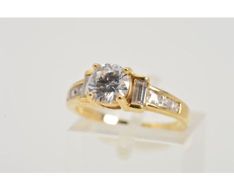 A 14CT GOLD CUBIC ZIRCONIA RING, designed as a circular cubic zirconia flanked by rectangular cubic zirconias and channel set