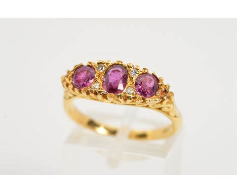A RUBY AND DIAMONDS RING, designed as three graduated rubies interspaced by four single cut diamonds, to the scrolling galler