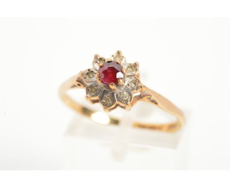 A 9CT GOLD RUBY AND DIAMOND CLUSTER RING, designed as a central circular ruby within a single cut diamond surround, with a 9c