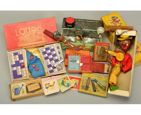 A BOXED PELHAM SM MINSTREL PUPPET, appears complete, in a worn yellow lidded box, with a quantity of assorted toys and games 