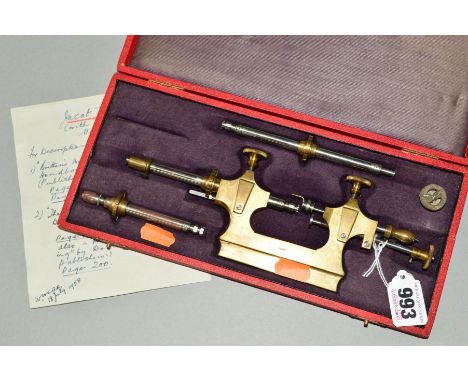A TOUR A PIVOTOR TOOL, in brass and white metal, contained in red leather case with gilt lettering (missing item)