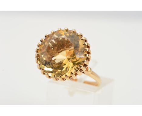 A 1960'S 9CT GOLD CITRINE RING, designed as a circular citrine within a multiple claw setting to the plain band with bead det