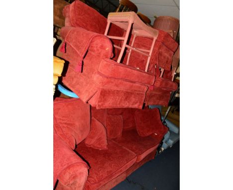 A RED UPHOLSTERED FOUR PIECE SUITE comprising of a two seater settee, width 230cm, two armchairs and a pouffe, together with 