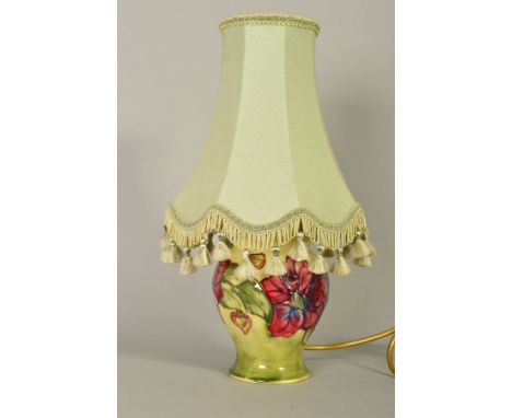 A SMALL MOORCROFT POTTERY TABLE LAMP AND SHADE, 'Clematis' pattern on yellow/cream ground, impressed and painted marks to bas