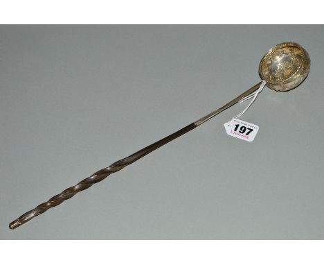 A GEORGIAN SILVER PUNCH LADLE WITH TWISTED WHALE BONE HANDLE, unmarked, inset with a heavily worn Queen Ann coin, length 38cm