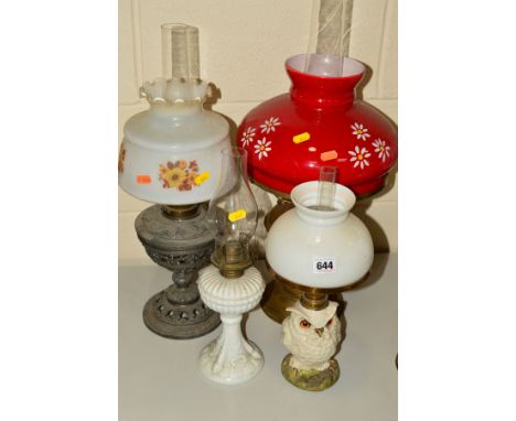 A CERAMIC OIL LAMP, in the form of an owl with glass eyes, opaque white shade, overall height 37cm, together with three other