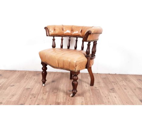 An early 20th century spindle back Library/Club chair, with horseshoe button backrest, upholstered in tan leather fabric, 76 