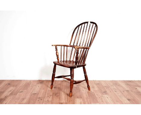 A 19th Century ash and elm comb back Windsor chair, with spindle back flanked by shaped elbow rests, 50 x 58 x 104cm high.