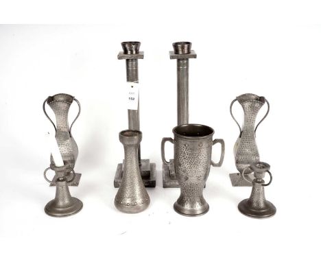 A pair of 20th Century Art Nouveau style hammered pewter twin handled vases, decorated with beaded rims, curved tapered bodie